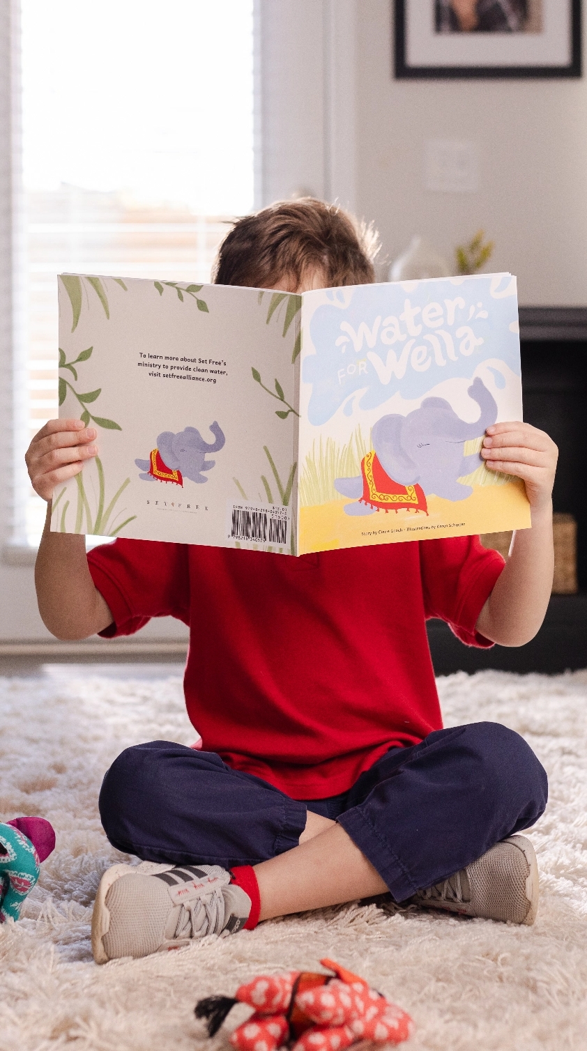 Child reading Water for Wella book